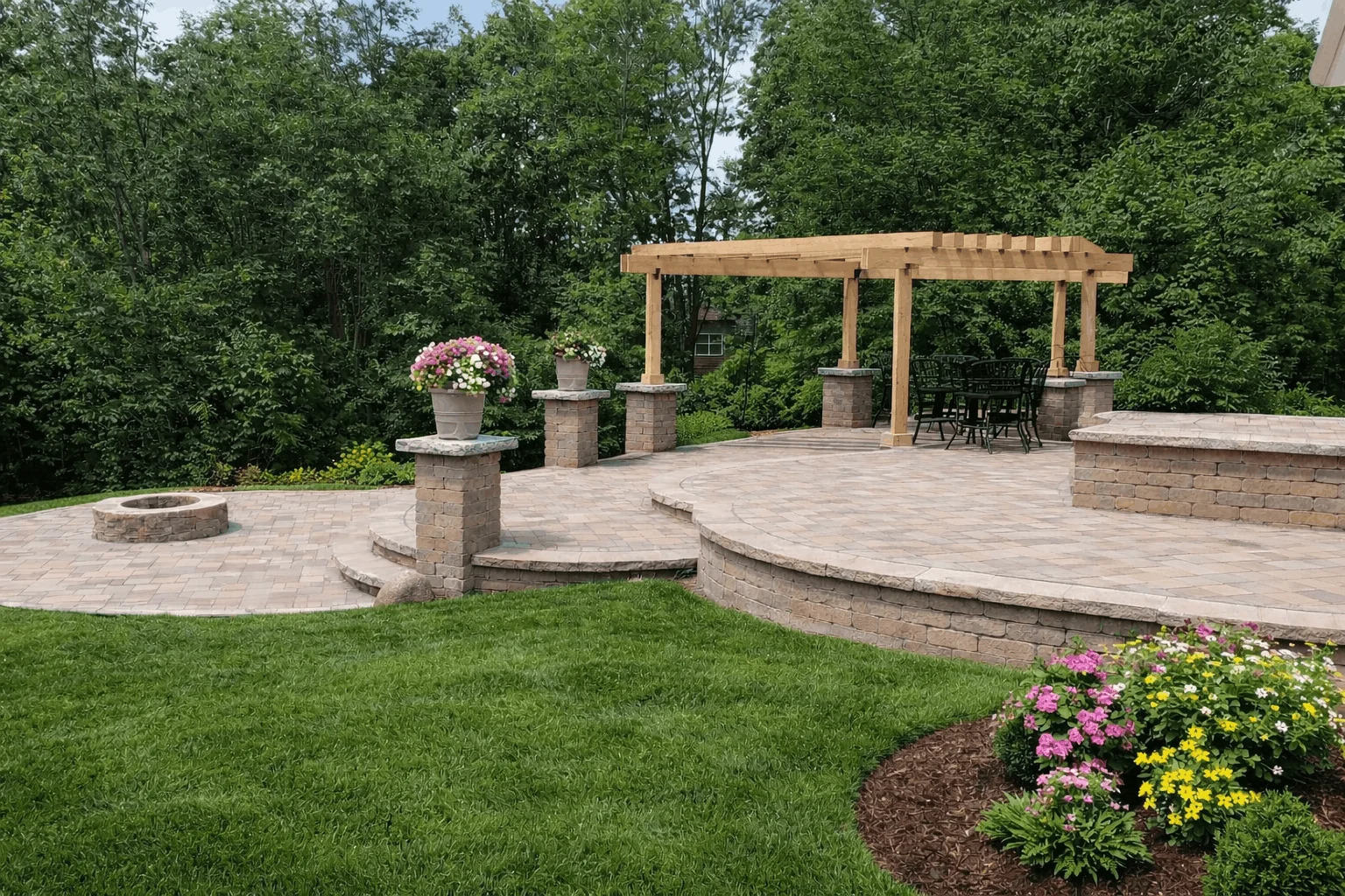 Multi-level paver patio with wooden pergola, seating area, and landscaped garden beds