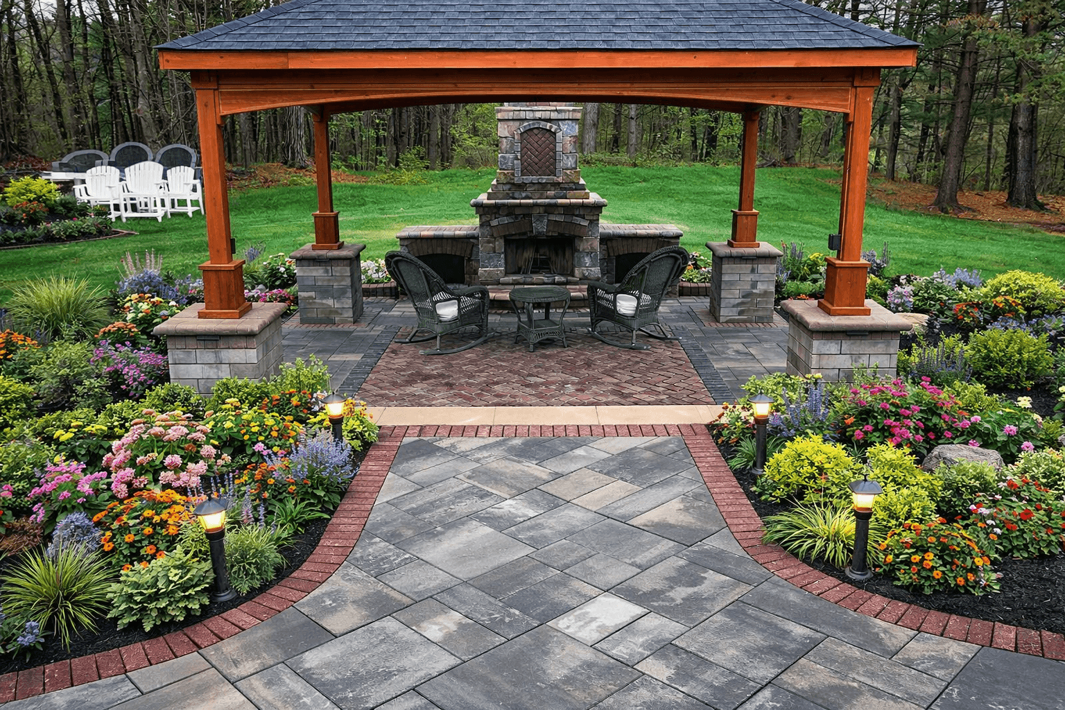 Stone patio with wooden pergola, outdoor fireplace, seating area, and landscaped garden beds.