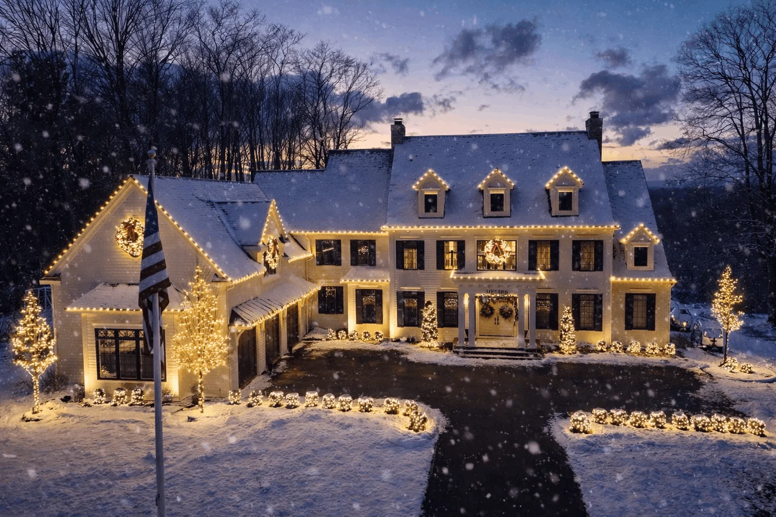 Snow-covered home glowing with Christmas lights and holiday decorations during a snowy winter night in New York