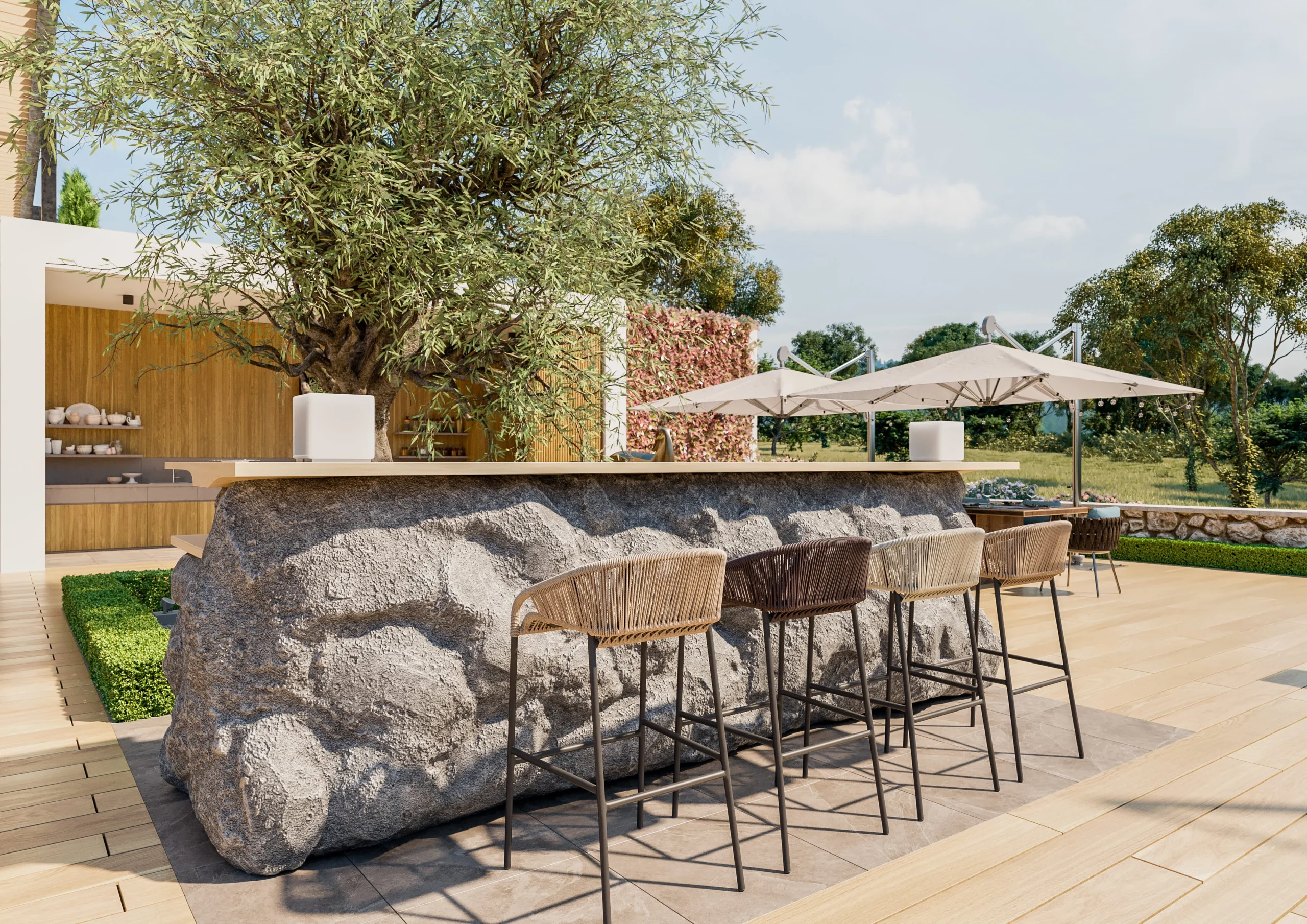 Outdoor bar seating with woven stools and stone island in a modern backyard kitchen area.